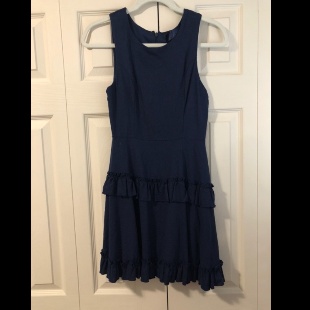 Navy dress with skirt ruffle detail.